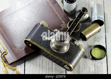 vintage Leica I camera with accessories on wooden background Stock Photo