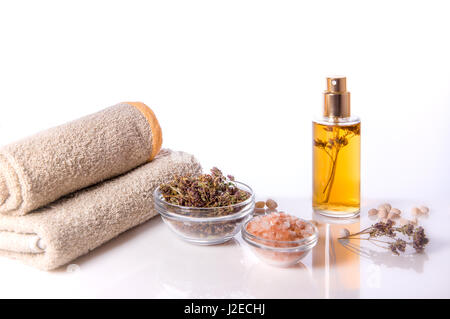 Spa background. Oregano and sea salt, towels. Dried herbs for use in alternative medicine, herbal cosmetic. Stock Photo