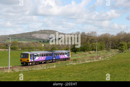 Pacer class 144 diesel multiple unit train In Northern livery in countryside on West Coast Main Line between Bolton-le-Sands and Carnforth Stock Photo