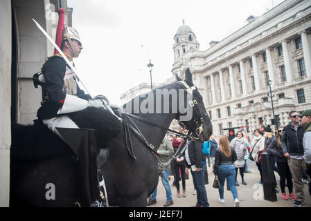London, UK. 27th Apr, 2017. The Queen's life guards are pictured at the Horse Guards Parade while on duty. Several tourists stop to see them and take pictures. Credit: Alberto Pezzali/Pacific Press/Alamy Live News Stock Photo