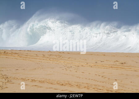 A big shore break Ocean wave breaking on the beach on the north shore of Oahu Hawaii Stock Photo