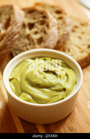 Bean pate with bread on wooden cutting board Stock Photo