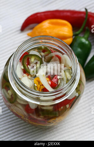 Fermented garlic and chili in glass bottle Stock Photo