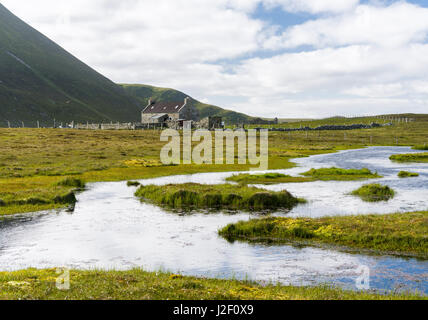 Foula part of the Shetland Islands, it is one of the most remote permanently inhabited islands in the UK. Croft with the Hamnafield in the background. (Large format sizes available) Stock Photo