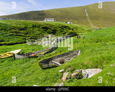 Foula part of the Shetland Islands, it is one of the most remote permanently inhabited islands in the UK. Settlement near Ham Voe and old row boats in the harbor Scotland (Large format sizes available) Stock Photo