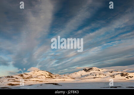 Mountains of Jotunheimen in evening light under a sky with cirrus clouds Stock Photo