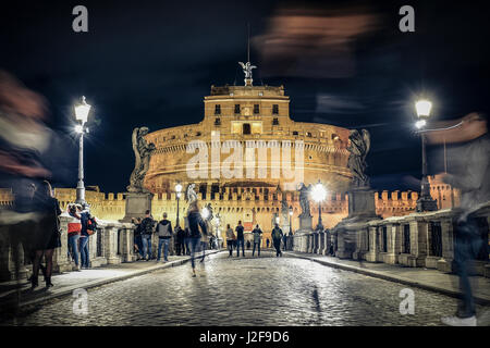 Ponte Sant'Angelo bridge crossing the river Tiber and Castel Sant'Angelo (AD 135), mausoleum of Hadrian, now a museum and art gallery illuminated at n Stock Photo
