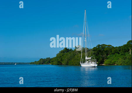 Sailboat anchoring at Aore Islet before Espiritu Santo Island, Vanuatu, South Pacific Stock Photo