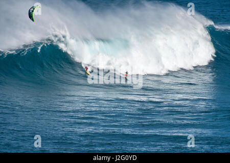 USA, Hawaii Maui. Robby Naish surfing alongside Niccolo Porcella windsurfing monster waves at Pe'ahi Jaws, North Shore Maui Stock Photo