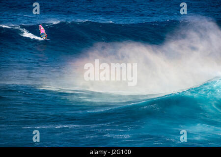 USA, Hawaii, Maui. World champion Robby Naish windsurfing monster waves at Pe'ahi Jaws, North Shore Maui. Stock Photo