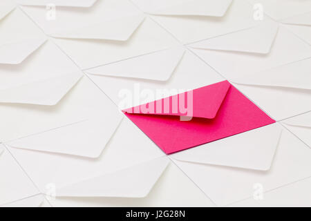 Composition with white envelopes and one pink envelope on the table. Stock Photo