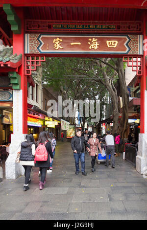 People walking through China Gate (Paifang) on Dixon street, Chinatown, Sydney, Australia Stock Photo