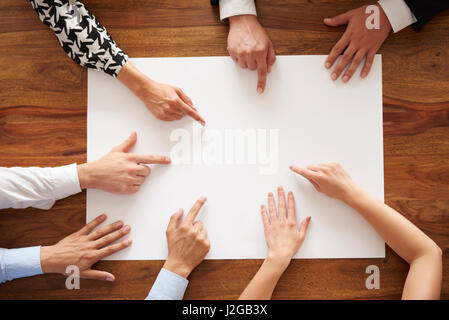 Human hands pointing at empty white card Stock Photo