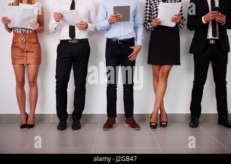 Human legs of people which waiting for job interview Stock Photo