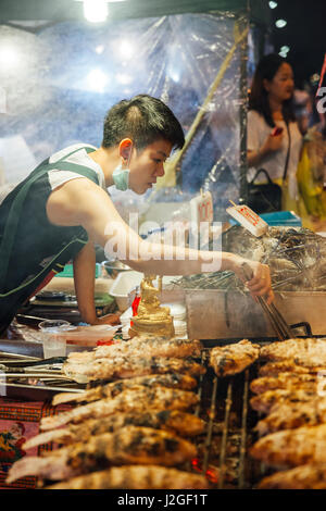 CHIANG MAI, THAILAND - AUGUST 27: Food vendor cooks fish and seafood at the Saturday Night Market (Walking Street) on August 27, 2016 in Chiang Mai, T Stock Photo