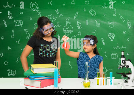 cute indian kids doing science experiment in chemistry lab or biology lab in school Stock Photo