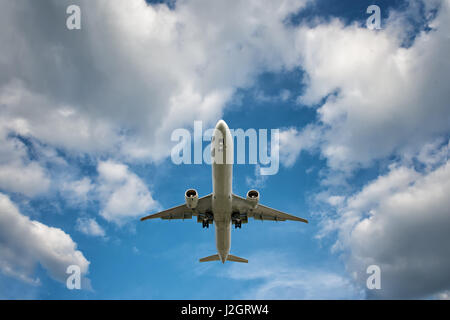 big jet plane on blue cloudy sky background Stock Photo