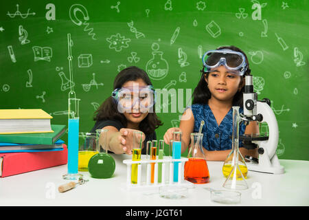 cute indian kids doing science experiment in chemistry lab or biology lab in school Stock Photo