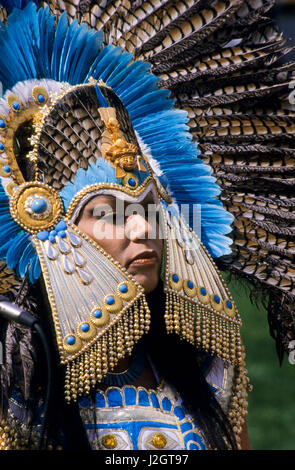 Aztec woman wears a magnificent traditional golden headdress made with blue stones and blue exotic bird feathers Stock Photo