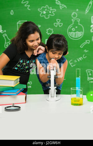 cute indian kids doing science experiment in chemistry lab or biology lab in school Stock Photo