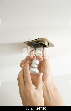electrician installing cable into ceiling Stock Photo - Alamy