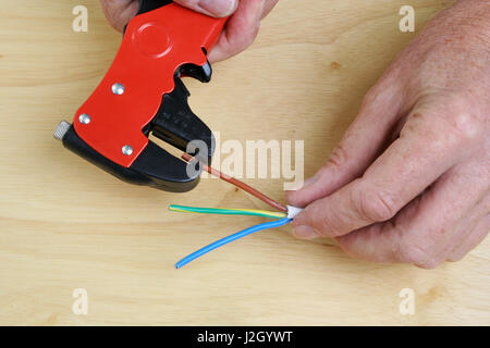 Stripping Electrical Wires with a special tool Stock Photo