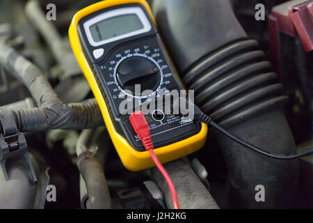 multimeter or voltmeter testing car battery Stock Photo