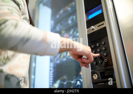 hand pushing button on vending machine keyboard Stock Photo