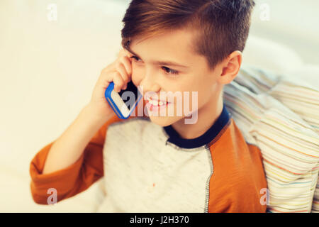 happy boy calling on smartphone at home Stock Photo