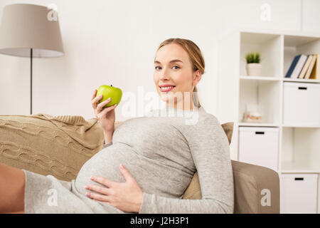 happy pregnant woman with green apple Stock Photo