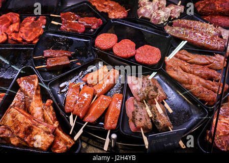 Marinaded meat for grilling in a counter display in a supermarket.  meat at the butcher Stock Photo