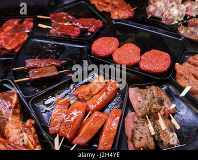 Marinaded meat for grilling in a counter display in a supermarket.  meat at the butcher Stock Photo