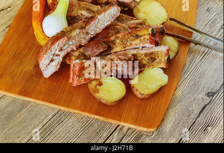 Sliced beef ribs in bbq sauce and baked potatoes,selective focus Stock Photo