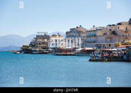 Elounda, Greece - October 14 2016: People are resting on a promenade of spa town of Elounda, autumn time Stock Photo
