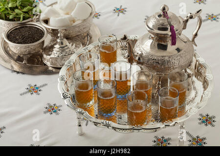 Traditional festive Moroccan silver tea set and glasses on the table Stock Photo