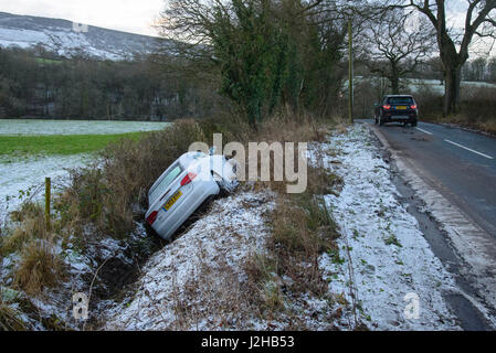 An Audi car slipped off an icy road and in a ditch, Whitewell, Lancashire. Stock Photo