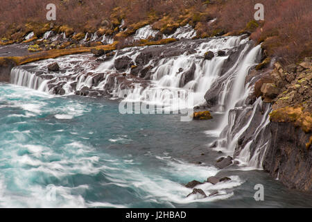 Hraunfossar, series of waterfalls pouring into the Hvítá river in winter, Vesturland, Borgarfjörður, western Iceland Stock Photo