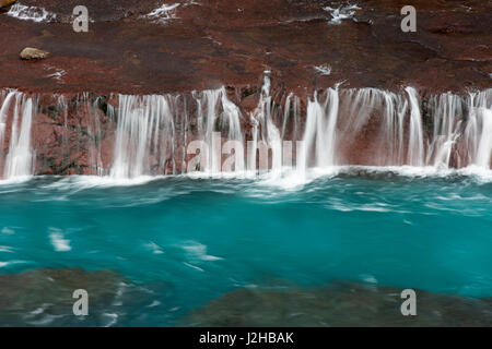 Hraunfossar, series of waterfalls pouring into the Hvítá river in winter, Vesturland, Borgarfjörður, western Iceland Stock Photo