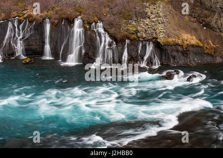 Hraunfossar, series of waterfalls pouring into the Hvítá river in winter, Vesturland, Borgarfjörður, western Iceland Stock Photo