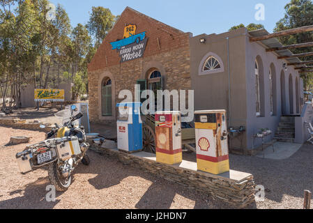 BARRYDALE, SOUTH AFRICA - MARCH 25, 2017: A motorcycle and historic fuel dispensers in front of a motel in Barrydale, a small town on the scenic Route
