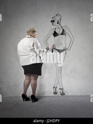 Fat woman drawing her ideal skinny figure Stock Photo