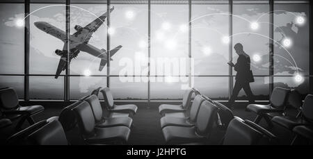 Silhouetted of businessman use mobile phone in airport at sunset. Business and connection concept. Elements of this image furnished by NASA Stock Photo
