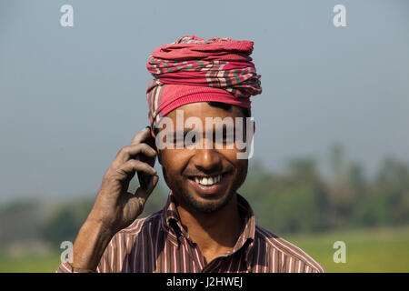 A farmer talks over the mobile phone. Munshiganj, Bangladesh. Stock Photo