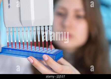 Female scientist using multi pipette in the laboratory. Stock Photo