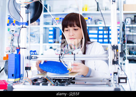 Female electronics student working in robotics laboratory. Stock Photo