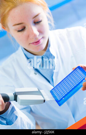 Female scientist using multi pipette. Stock Photo