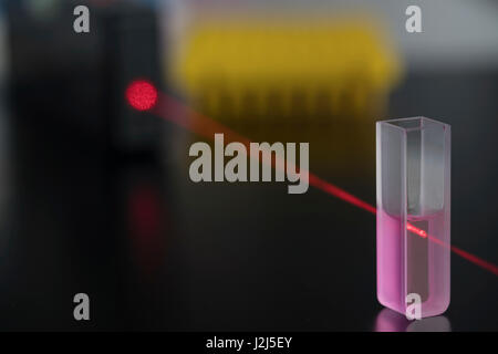 Cuvette with red laser beam. Stock Photo