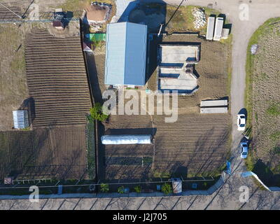 Buildings on the site. Hangar from metal profile, corrugated. The foundation of the house Stock Photo