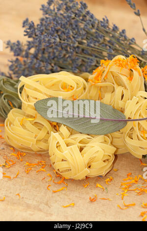 Coloured noodles with mediteranen herbs Stock Photo