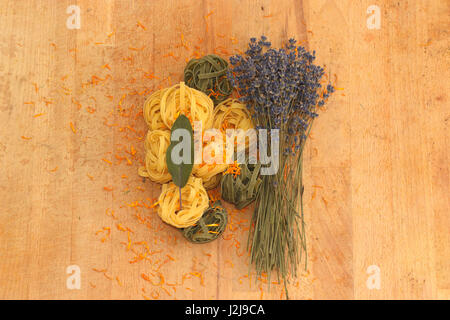 Coloured noodles with mediteranen herbs Stock Photo